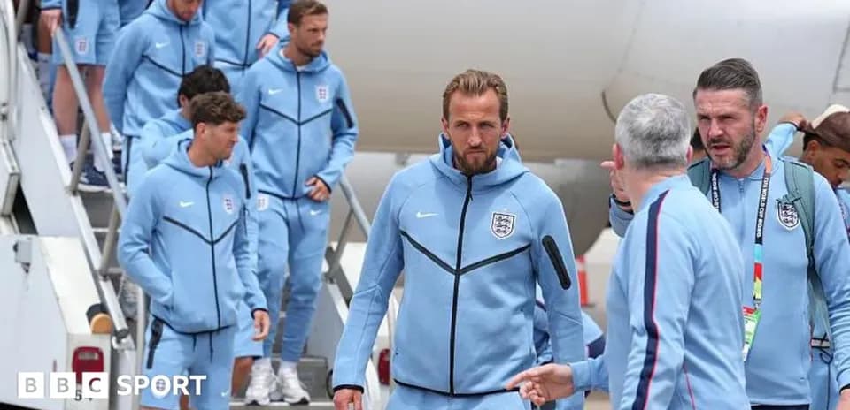 England team disembarking from plane in training gear
