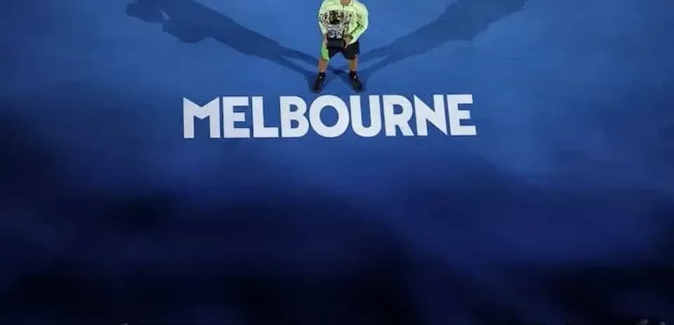 Tennis player holding trophy on Melbourne court