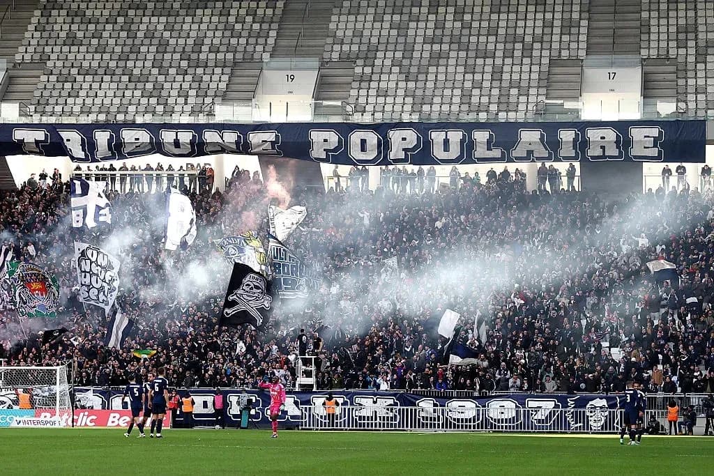 Football fans celebrating with banners and smoke