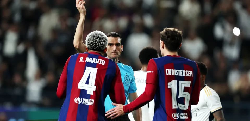 Referee shows yellow card to player during match