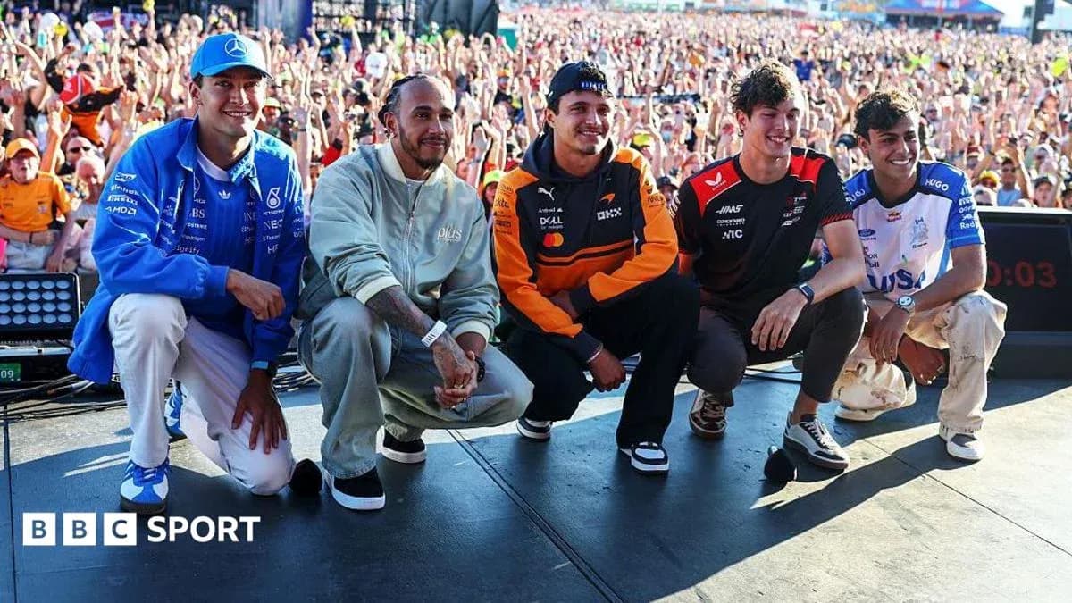 Formula 1 drivers posing on stage at event