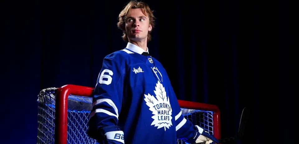 Hockey player in Toronto Maple Leafs jersey near goal
