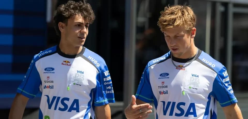 Two race team members discussing in paddock area