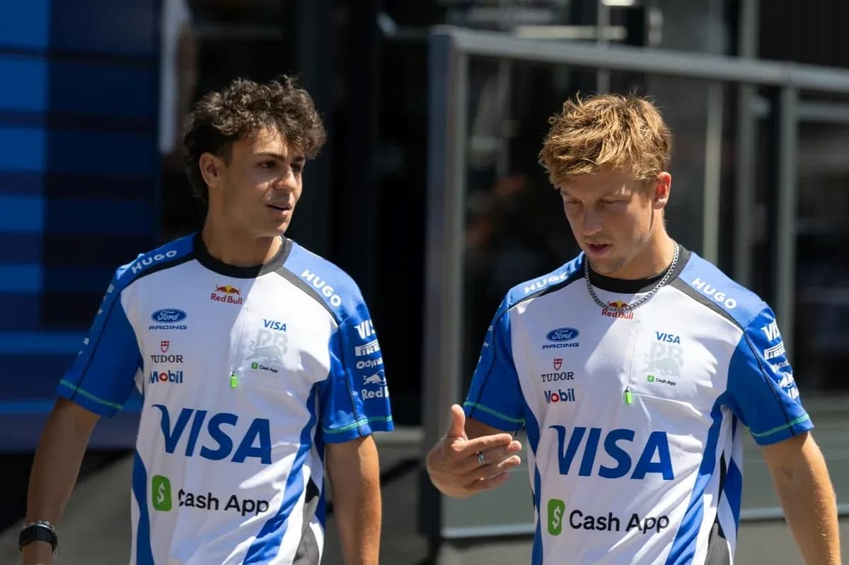 Two race team members discussing in paddock area