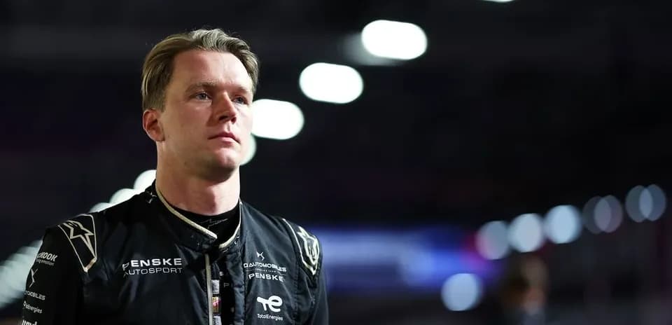 Penske Autosport driver in racing suit at night