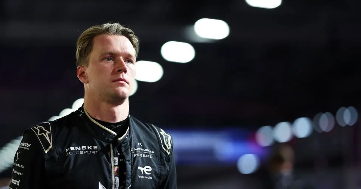 Penske Autosport driver in racing suit at night