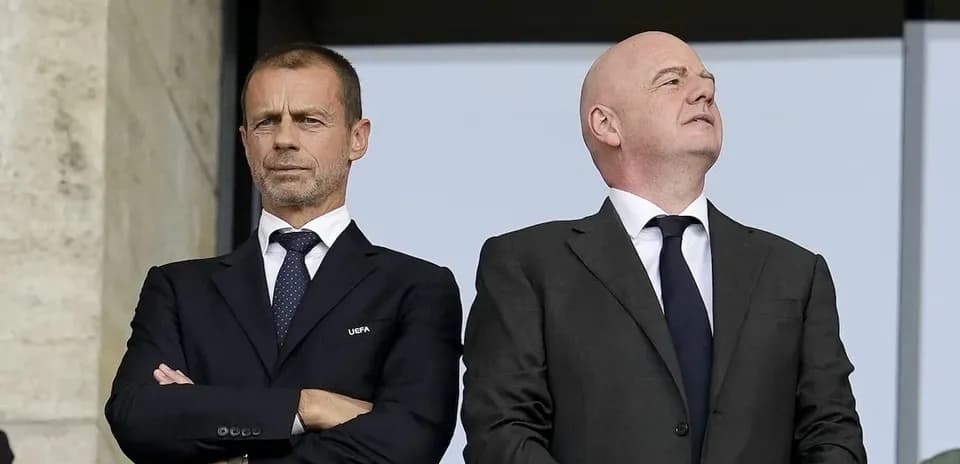 Two football officials observing from VIP box