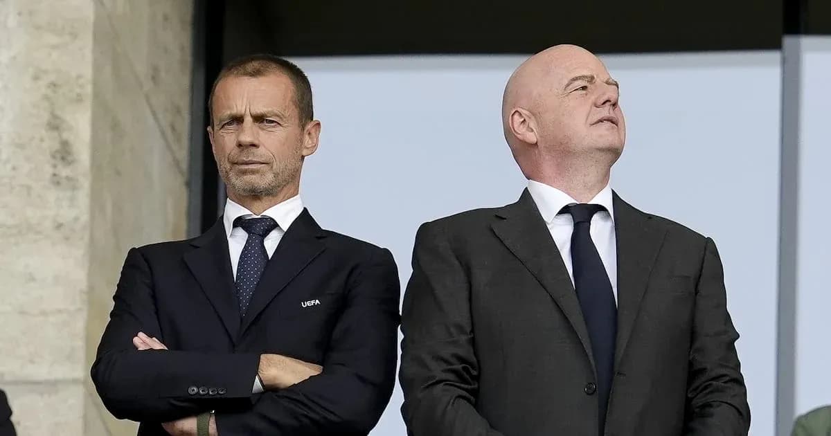 Two football officials observing from VIP box