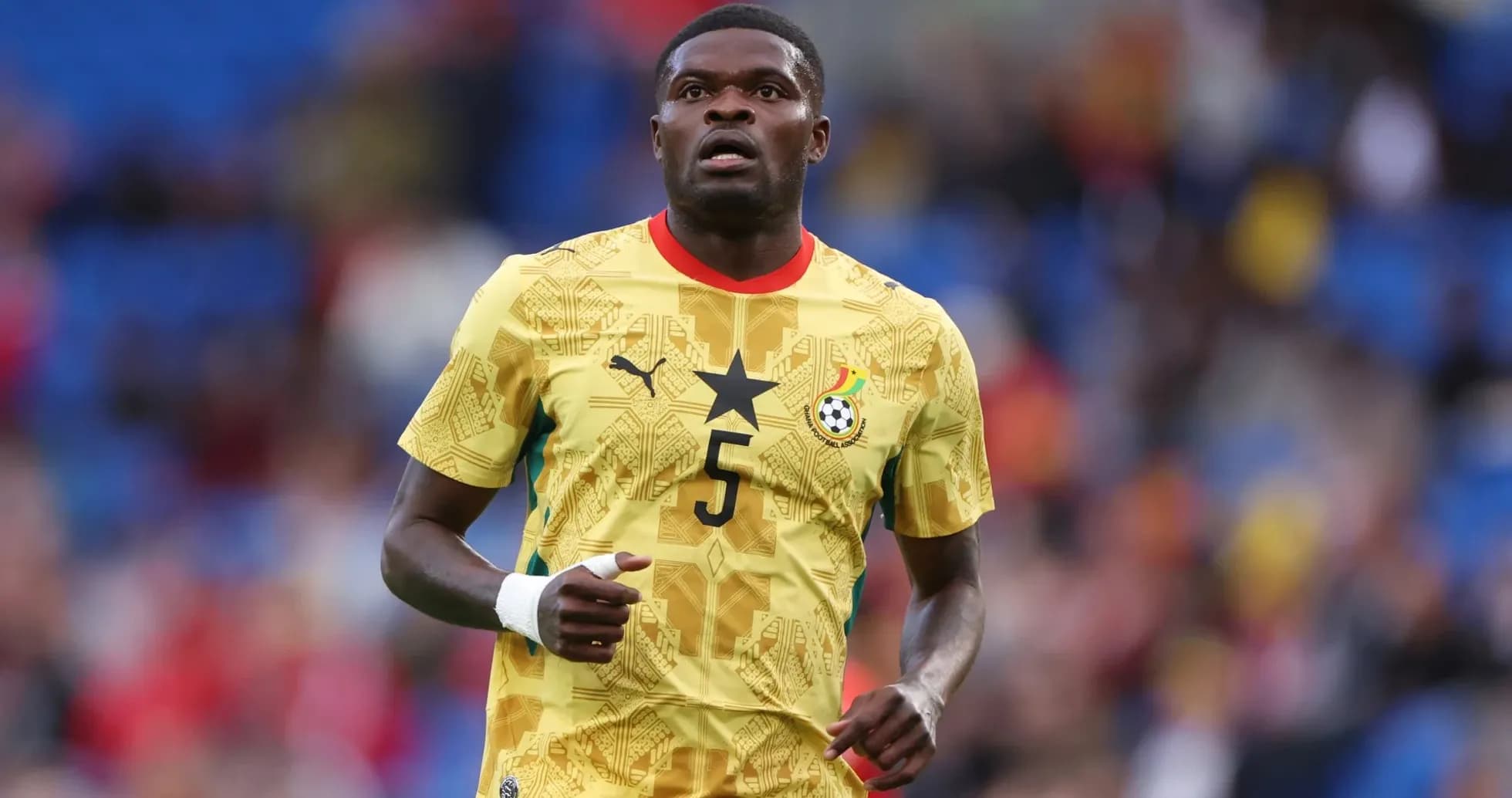 Ghana player in yellow kit during match