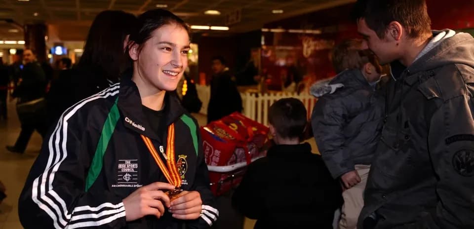 Athlete wearing medal at an airport