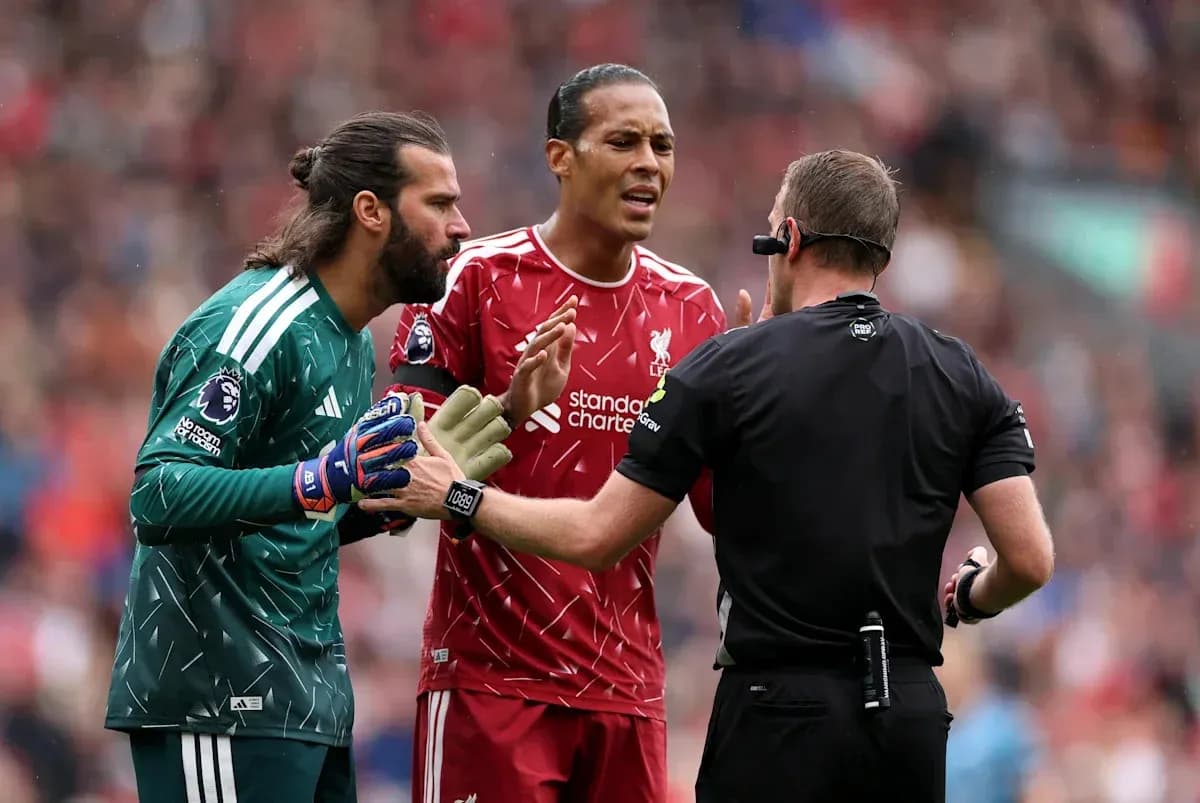 Liverpool players discussing with referee during match
