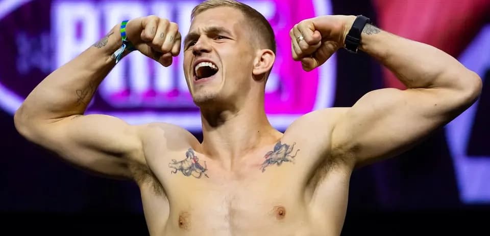 Athlete flexing muscles at weigh-in event