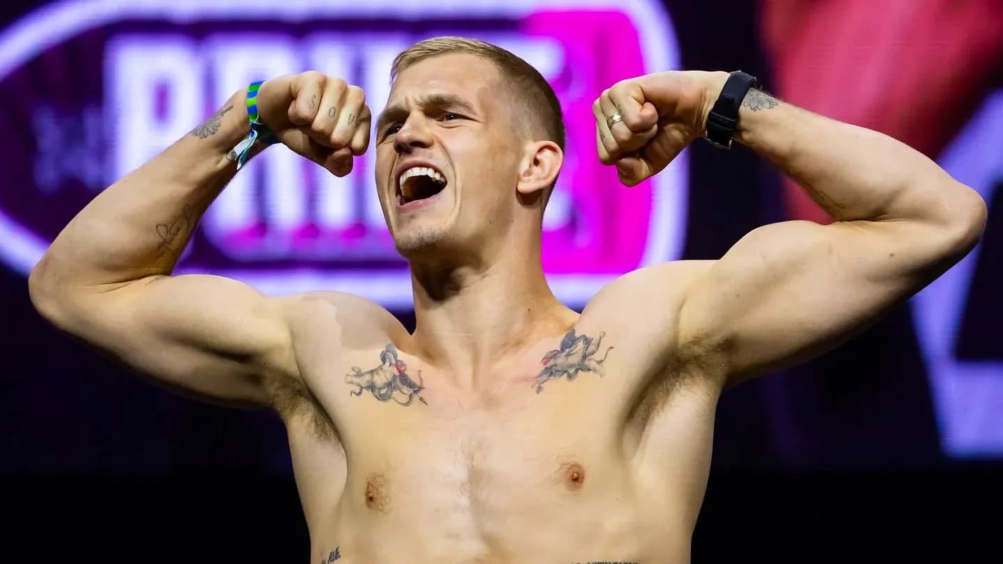 Athlete flexing muscles at weigh-in event