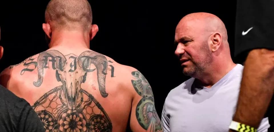 Fighter with tattoos talking to UFC official