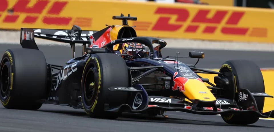 Formula 1 car racing on track with DHL backdrop