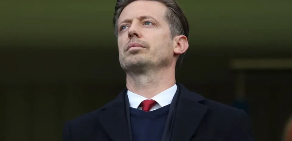 Man observing from the stands at a stadium