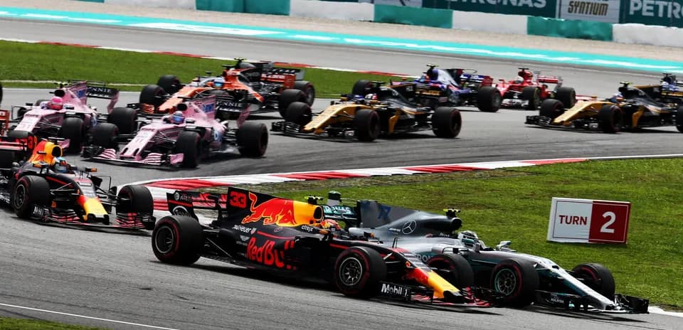 Formula 1 cars racing at Turn 2 on track