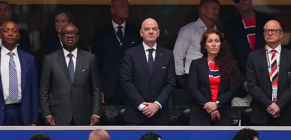 Officials standing together in stadium VIP area