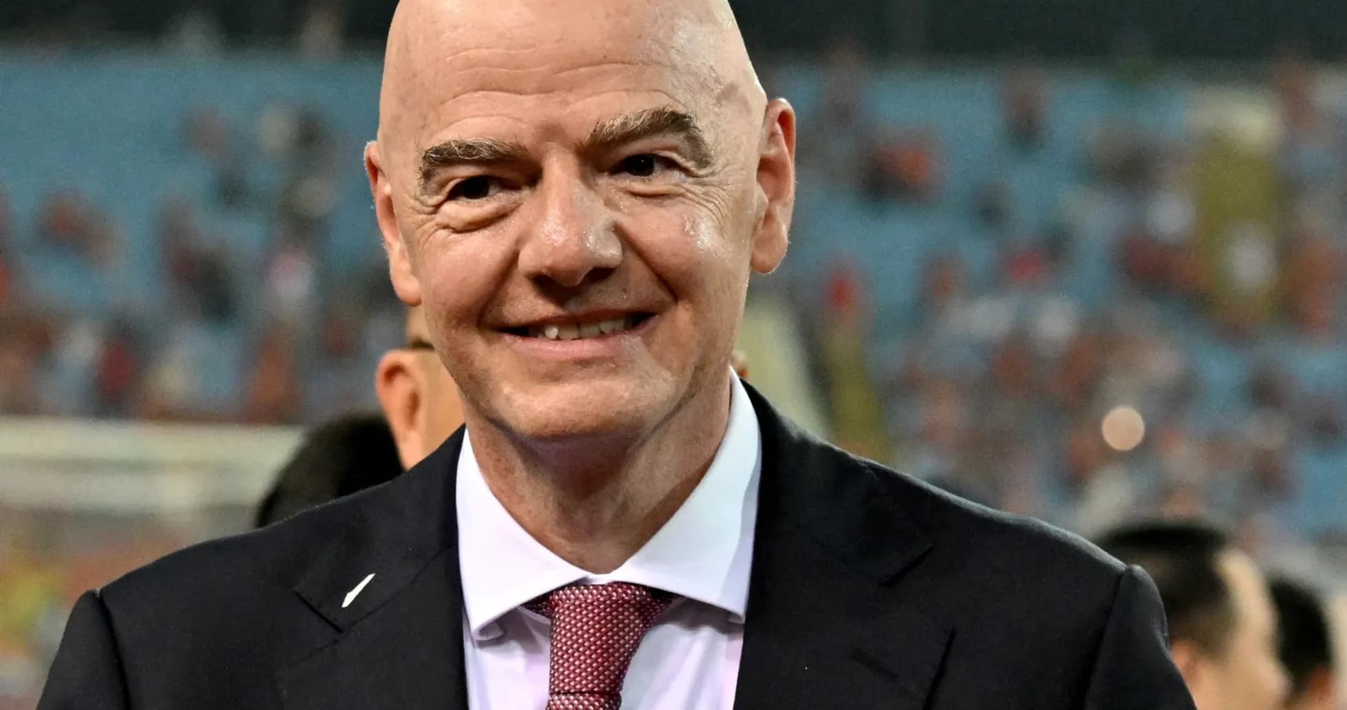 FIFA president smiling during event at stadium