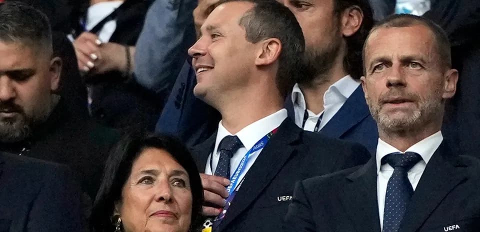 Officials watching a match from the stands