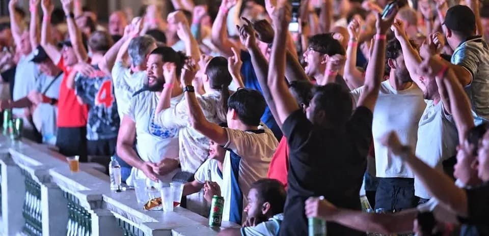 Fans celebrating during a sports event in a venue