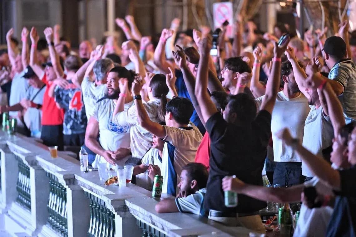 Fans celebrating during a sports event in a venue