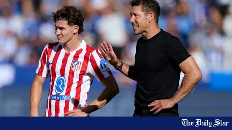 Atletico Madrid coach instructing player on sideline