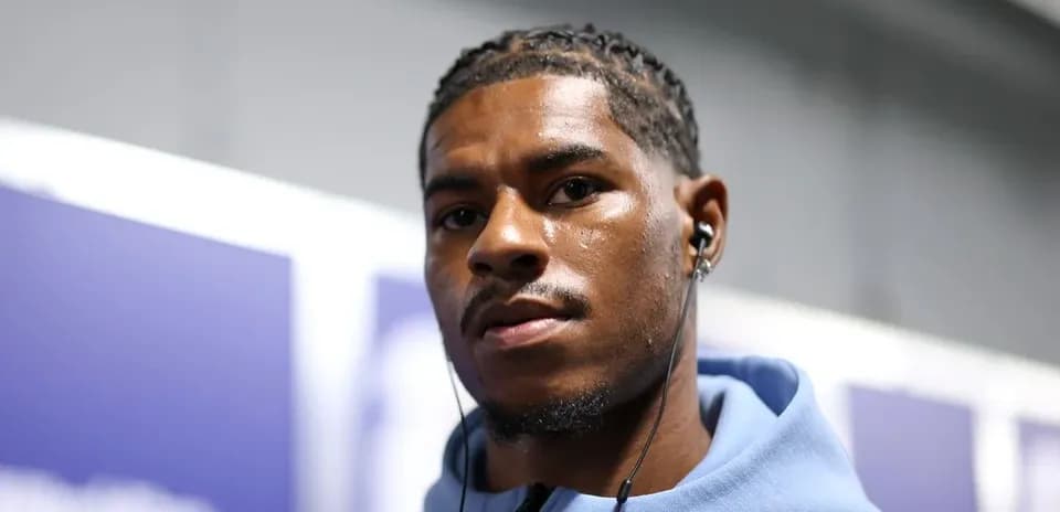 Player wearing headphones in corridor before match