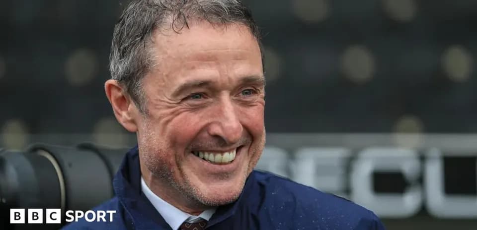 Coach smiling during a press conference