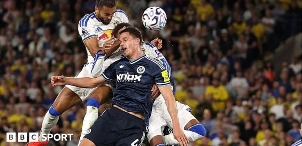 Two players challenging for the ball during match