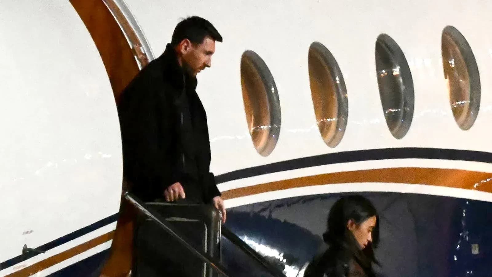 Football player disembarking from private jet