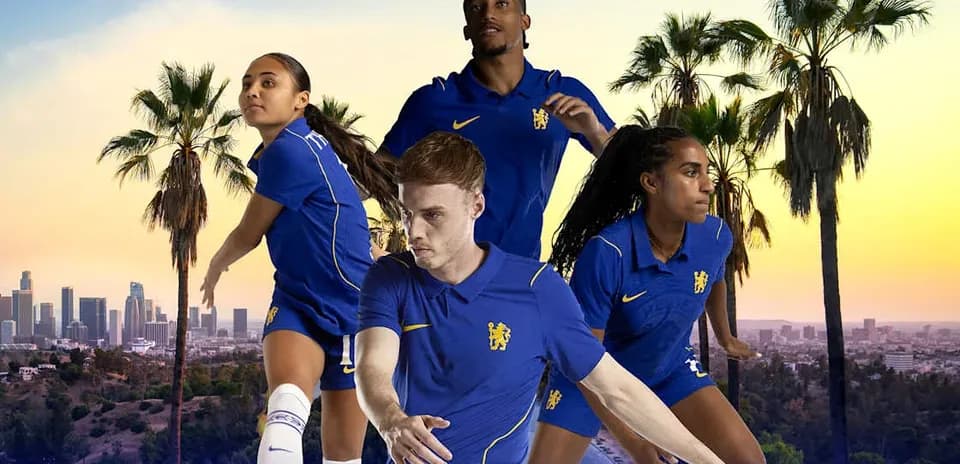 Four football players in blue kits against city backdrop