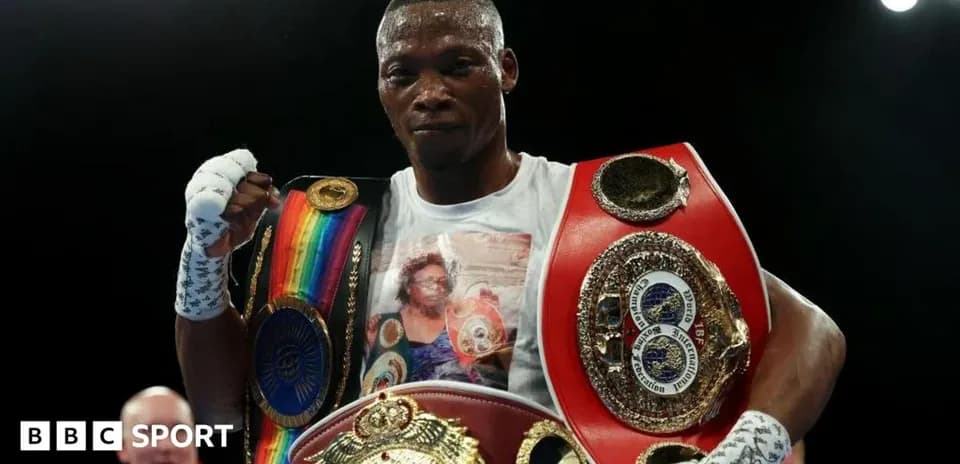 Boxer celebrating victory with multiple championship belts