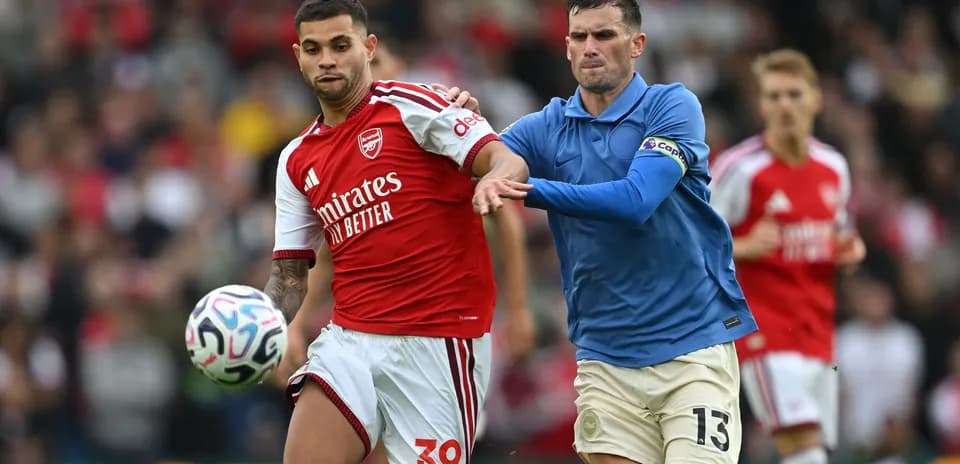 Two players competing for the ball in match