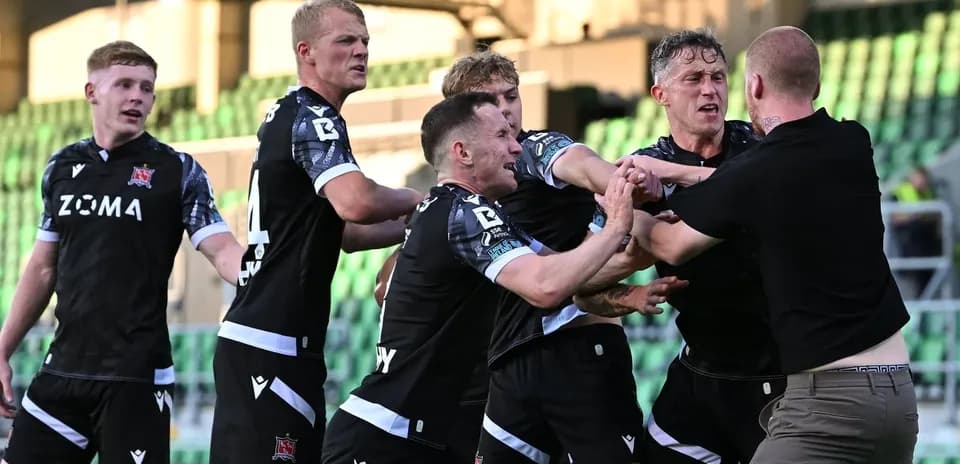 Drogheda United players confronting a pitch invader