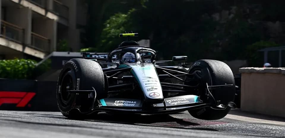 Formula 1 car racing around corner on track
