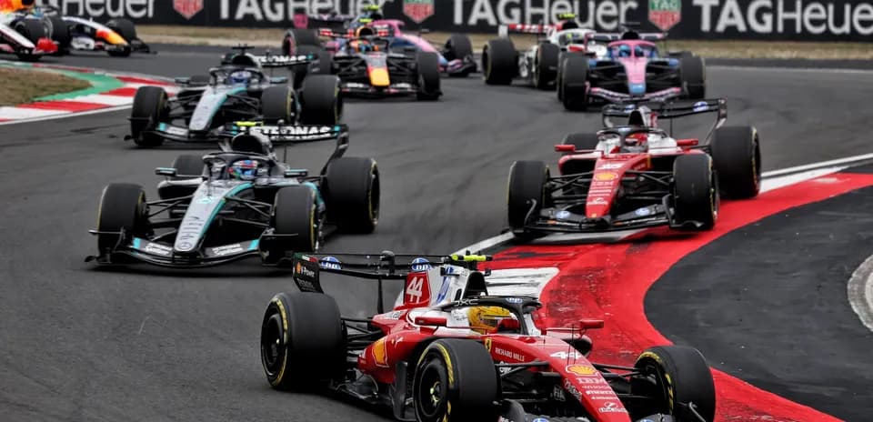 Formula 1 cars racing on a track during competition