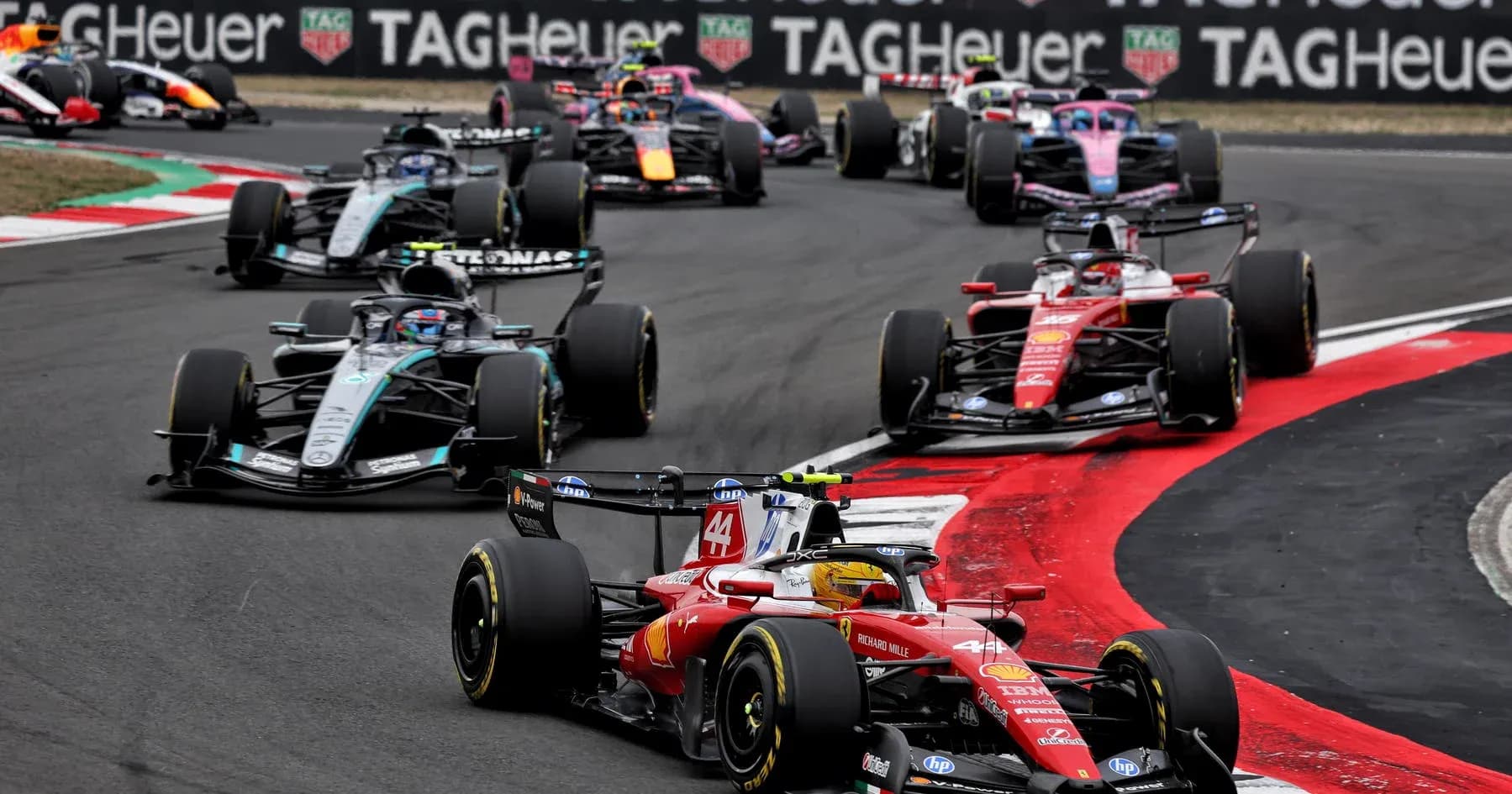 Formula 1 cars racing on a track during competition