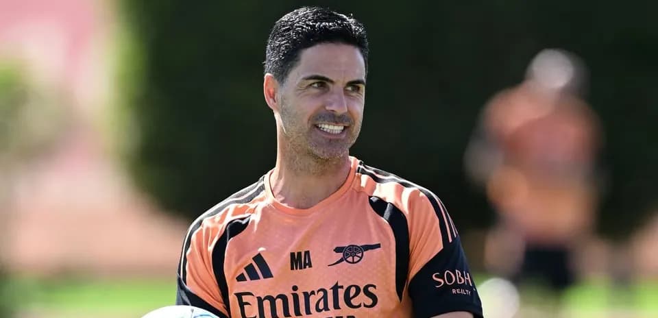 Mikel Arteta holding a ball during training session