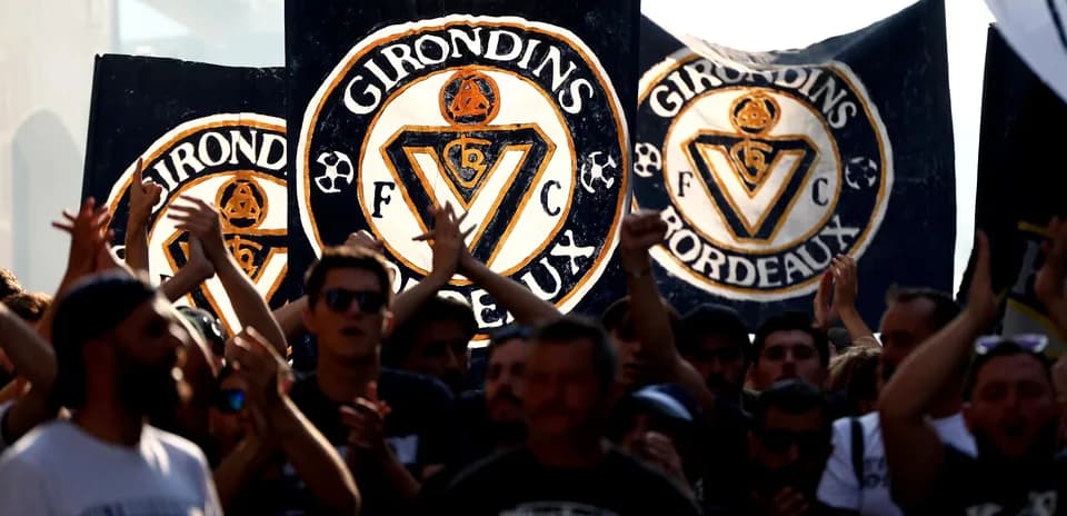 Girondins de Bordeaux fans holding banners during event