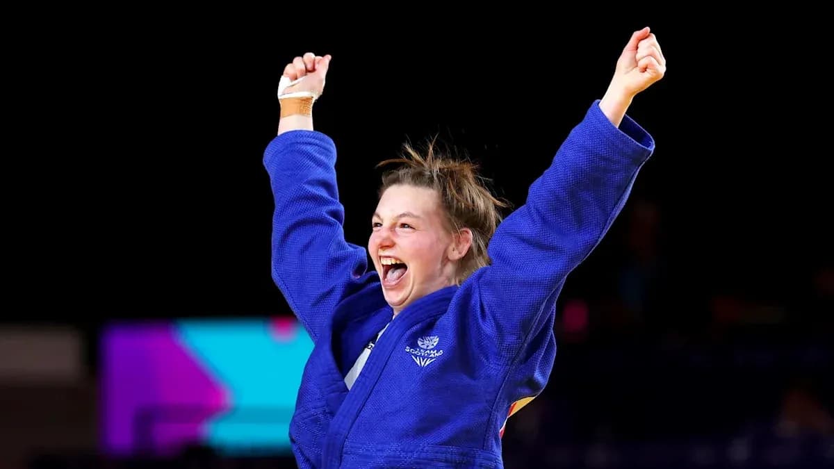Judo athlete celebrating victory with raised arms