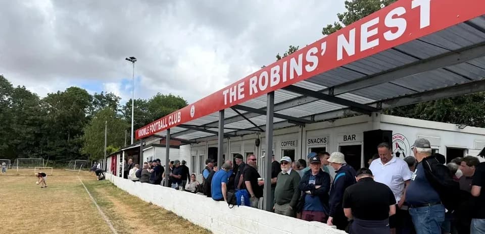 Fans gathered outside Knowle Football Club's stand