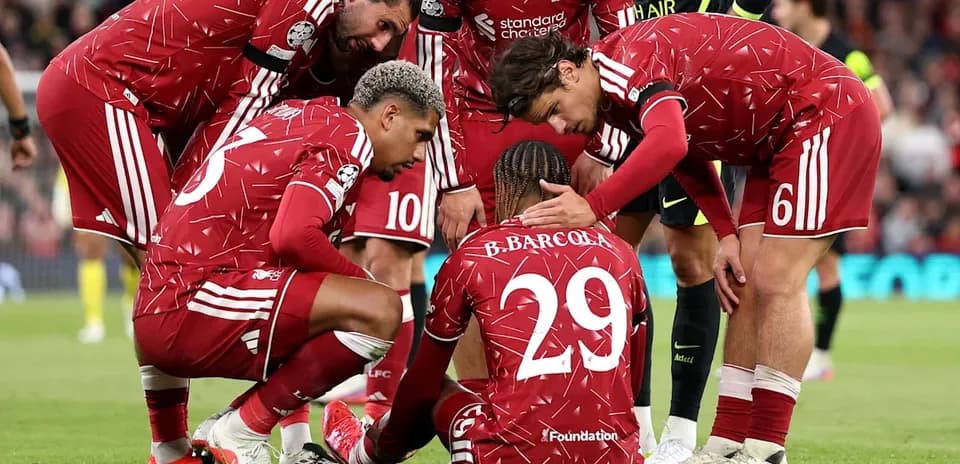 Liverpool players gathered around injured teammate on pitch