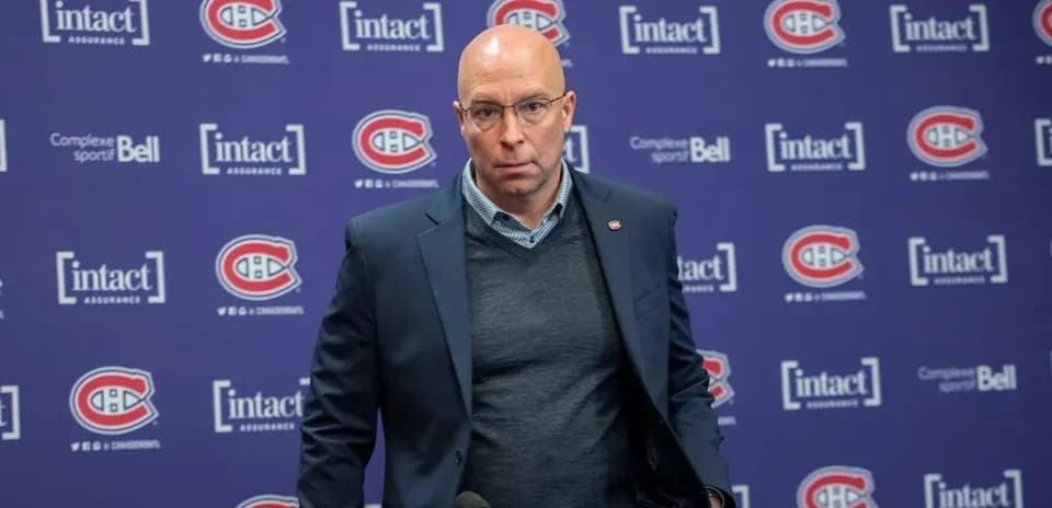 Man at podium during press conference with Canadiens branding