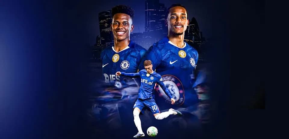 Chelsea players posing with football in blue jerseys