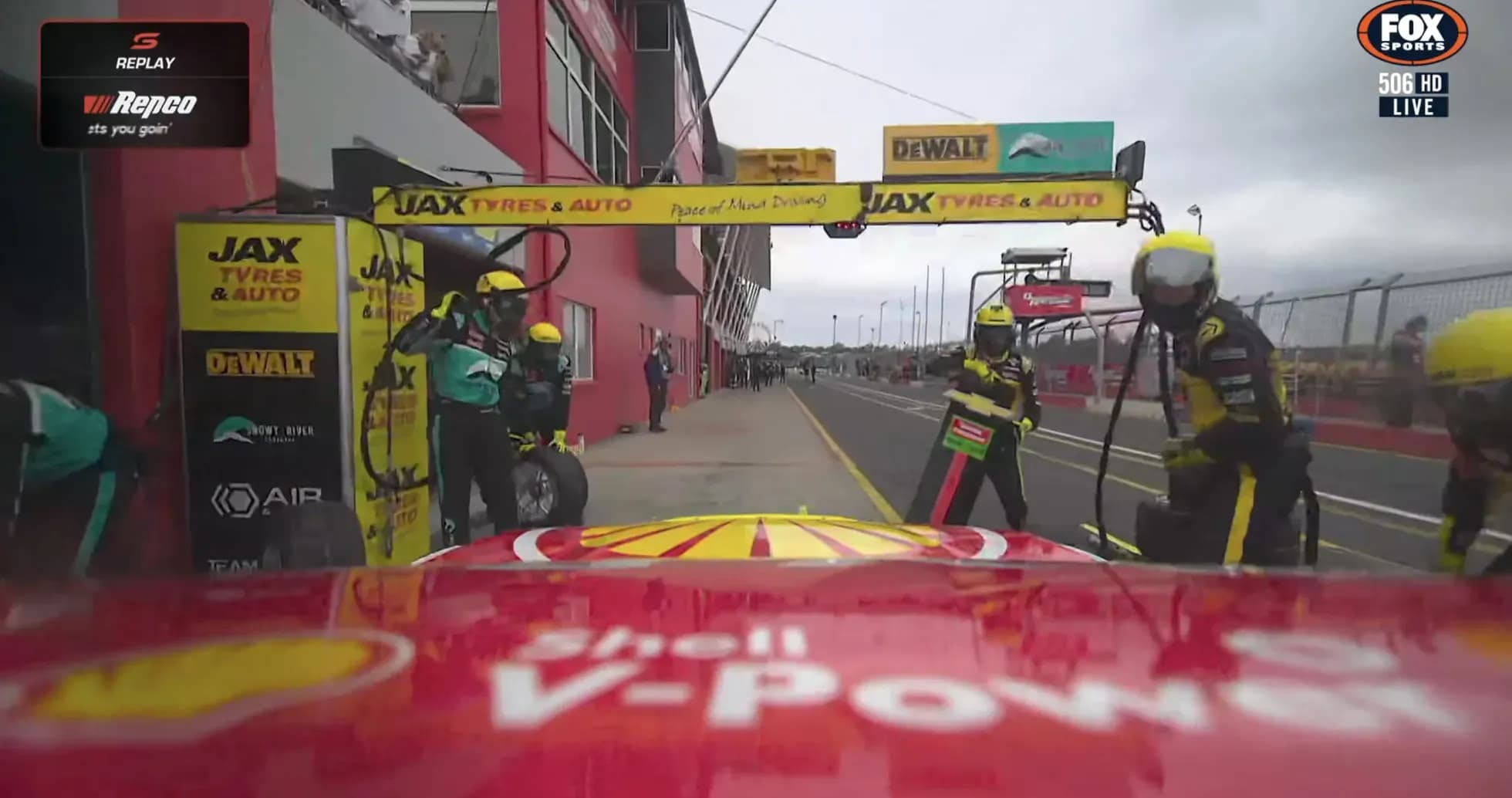 Pit crew servicing car during pit stop at race
