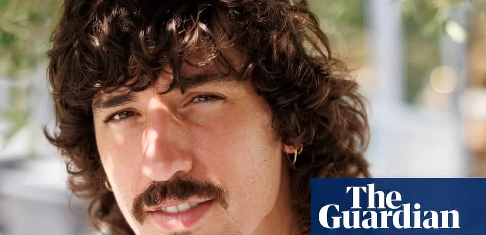 Yoshigiri with curly hair and mustache close-up