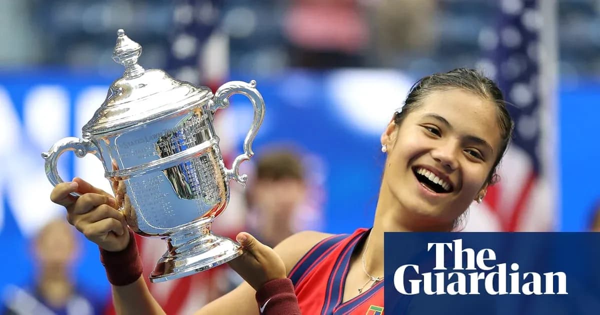 Tennis player holding US Open trophy in celebration