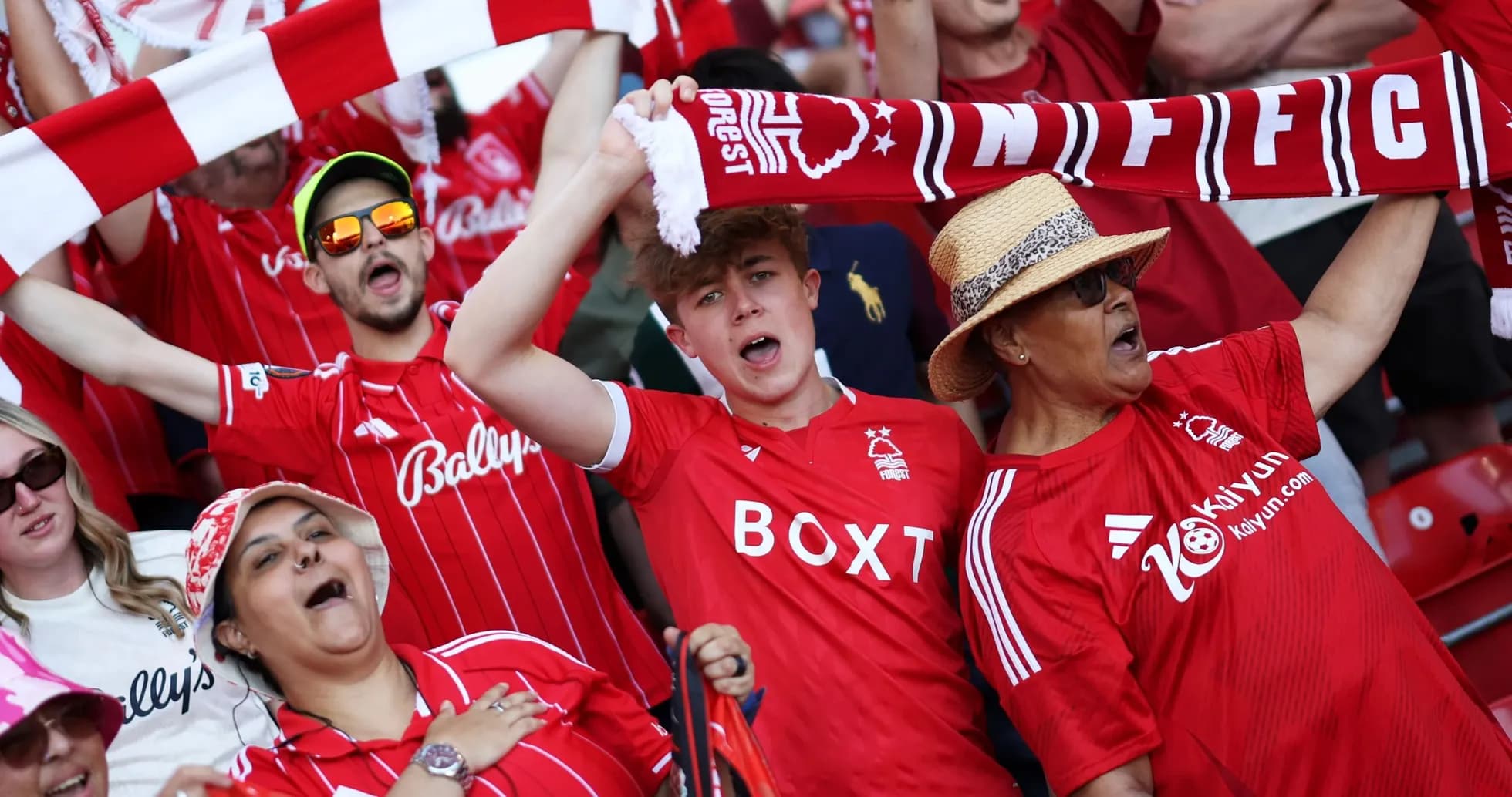 Fans celebrating in Nottingham Forest jerseys at stadium