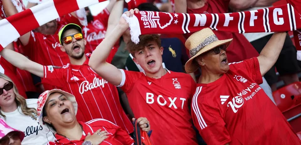 Fans celebrating in Nottingham Forest jerseys at stadium